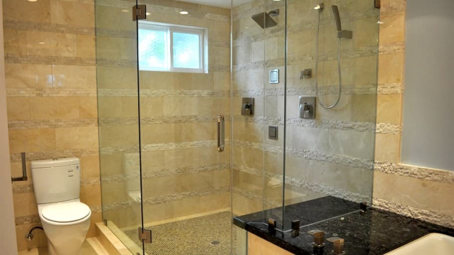 A small bathroom with frameless glass shower doors